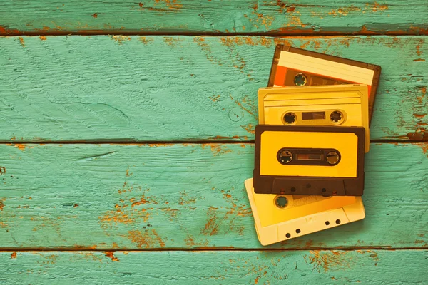 Close up photo of vintage cassette tape over aqua wooden table . top view. retro filtered — Stock Photo, Image