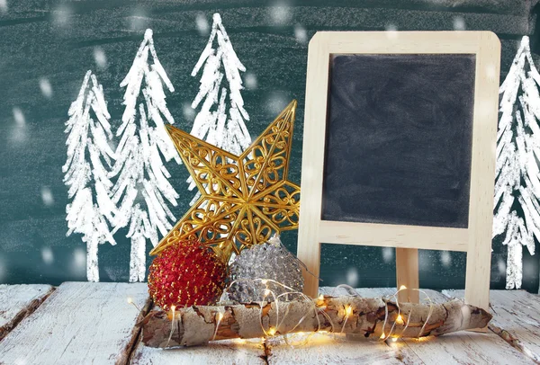 Christmas decorations and chalkboard — Stock Photo, Image