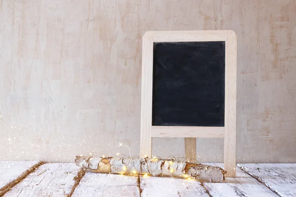 Christmas decorations and chalkboard — Stock Photo, Image