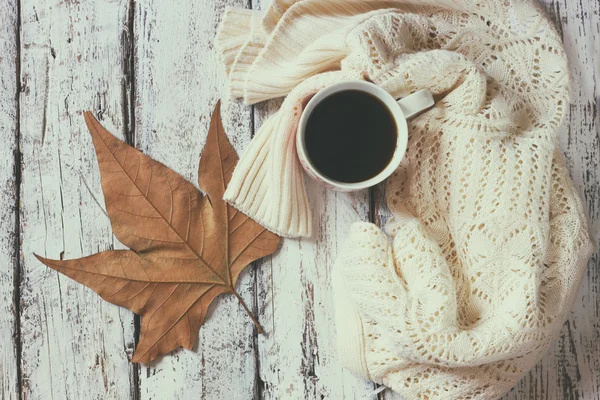 Sweater with to cup of coffee and autumn leaf — Stock Photo, Image