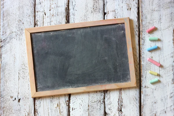 Empty blackboard with chalks — Stock Photo, Image