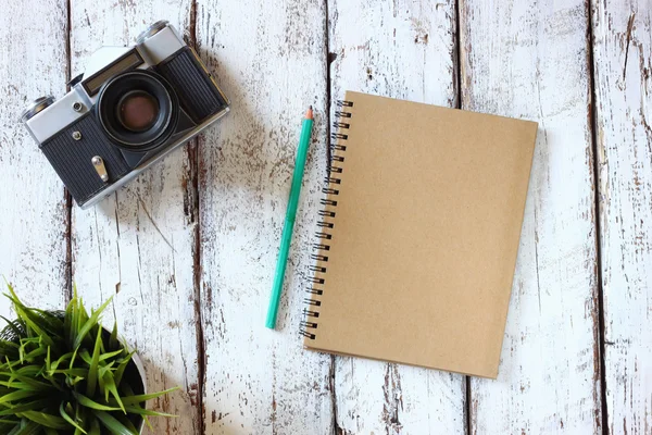 空白笔记本和旧相机 — 图库照片