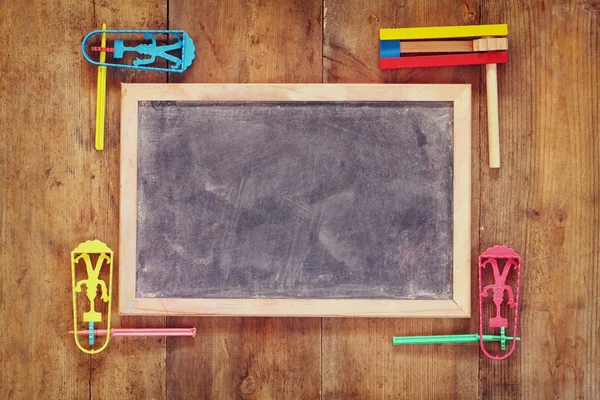 Noisemaker for Purim celebration (jewish carnival holiday) next to chalkboard — Stock Photo, Image