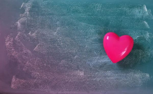 Top view image of pink plastic heart on blackboard background. valentine's day celebration concept. filtered and toned photo — Stock Photo, Image