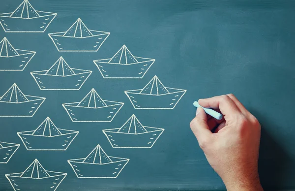 Leadership Concept image, male hand drawing boats over chalkboard — Stock Fotó