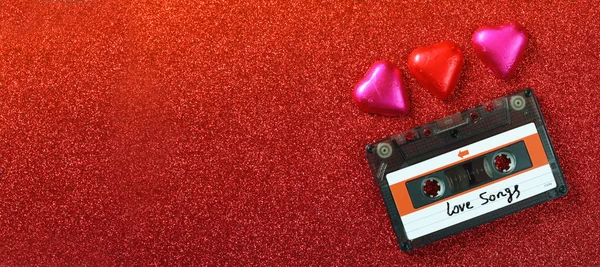 Website banner image of colorful heart shape chocolates and audio cassette on glitter background. valentine's day celebration concept. retro toned and filtered — Φωτογραφία Αρχείου