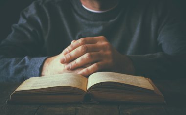 dua kitabı yanında oturan kişinin düşük anahtar görüntüsü