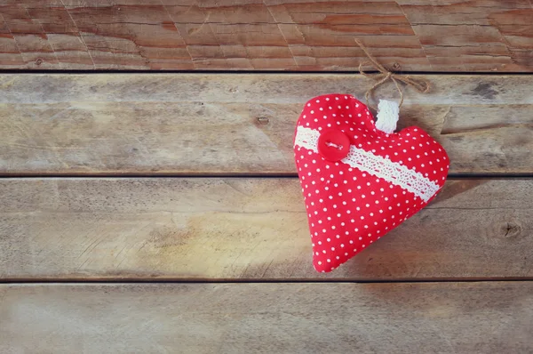 Imagen de corazón de tela de colores en la mesa de madera. Concepto de celebración del día de San Valentín. retro filtrado — Foto de Stock