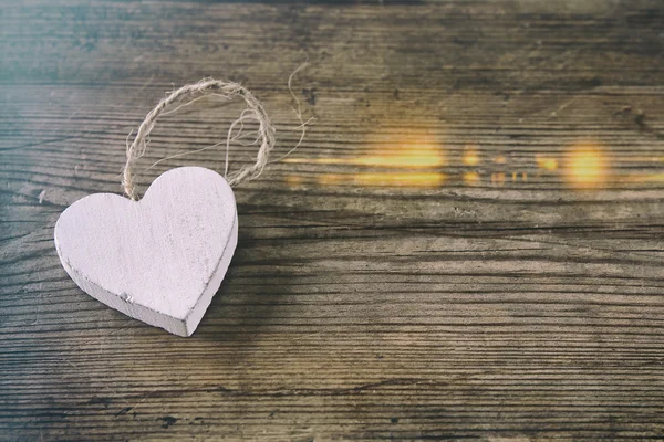 Selective focus photo of wooden heart on rustic table.  valentine's day celebration concept. vintage filtered — Stock Photo, Image