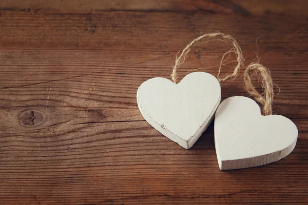 Foyer sélectif photo de couple de coeurs en bois sur la table rustique. concept de célébration de la Saint-Valentin. vintage filtré et tonique — Photo