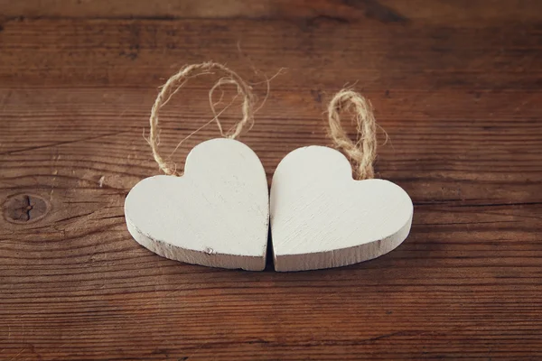 Selective focus photo of couple of wooden hearts on rustic table.  valentine's day celebration concept. vintage filtered and toned — Stock Photo, Image