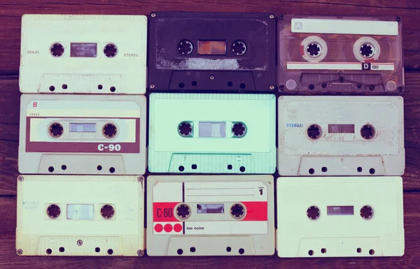Close up photo of cassette tape over wooden table . top view. retro filtered — Stockfoto