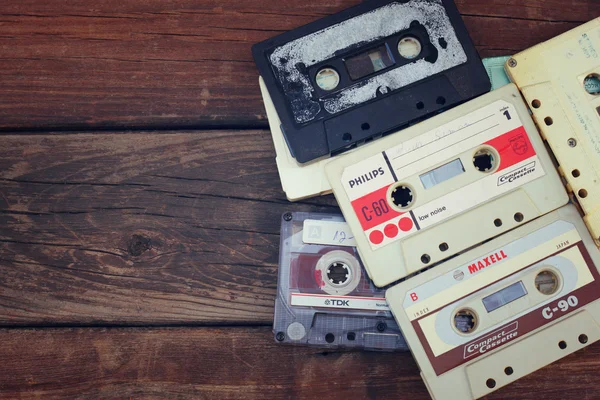 Close up photo of cassette tape over wooden table . top view. retro filtered — Stok fotoğraf