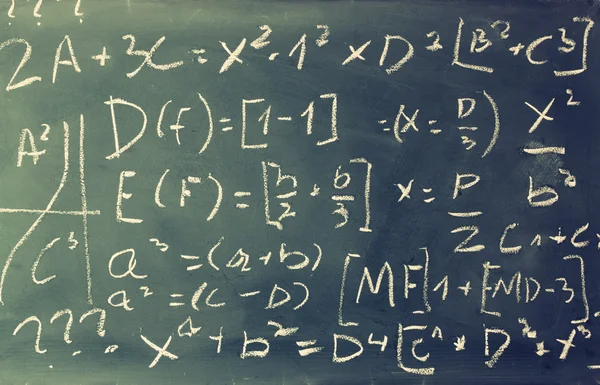 Visão lateral de fórmulas matemáticas e cálculo escrito sobre quadro-negro. foco seletivo . — Fotografia de Stock