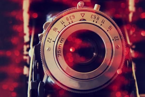 Abstract photo of old camera lens with glitter overlay. image is retro filtered. selective focus — Zdjęcie stockowe