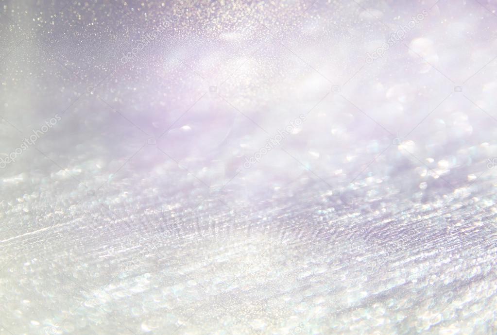 glitter vintage lights background. light silver, purple and pink. defocused.