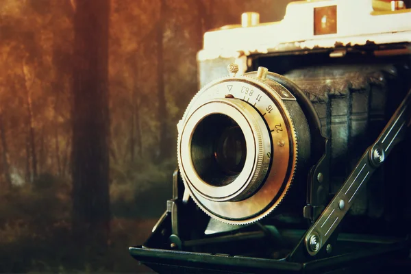 Double exposure and abstract photo of old vintage camera lens over wooden table. selective focus — Stockfoto