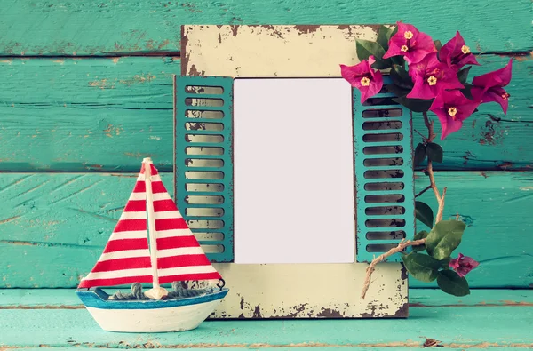 Vintage blank frame, sailboat next to beautiful purple mediterranean summer flowers. vintage filtered image. template, ready to put photography — Stock fotografie