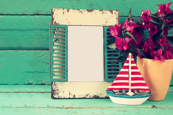 Vintage blank frame, sailboat next to beautiful purple mediterranean summer flowers. vintage filtered image. template, ready to put photography — Stock Photo, Image