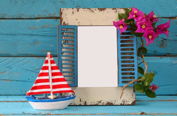 Vintage blank frame, sailboat next to beautiful purple mediterranean summer flowers. vintage filtered image. template, ready to put photography — Stock fotografie