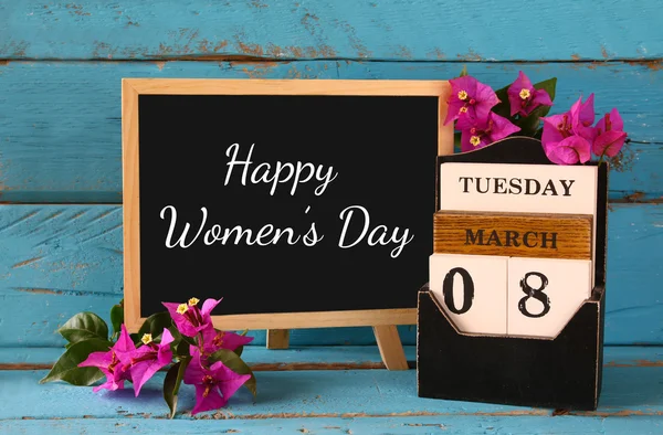 Wooden March 8 calendar, next to purple flowers on old blue rustic table. selective focus. vintage filtered. Happy International Women's Day concept — Stockfoto