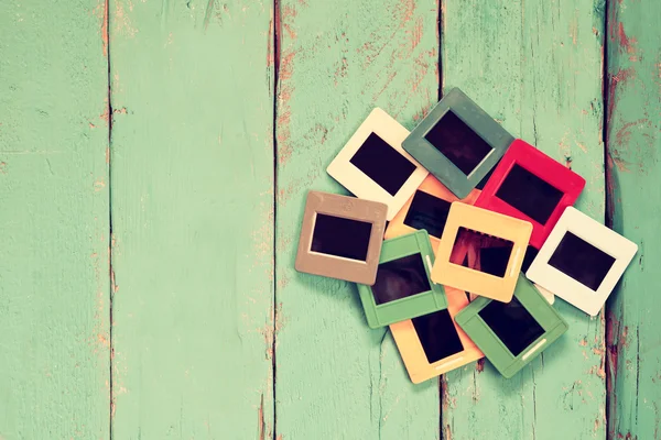 Top view of old slides frames over wooden blue background — Zdjęcie stockowe