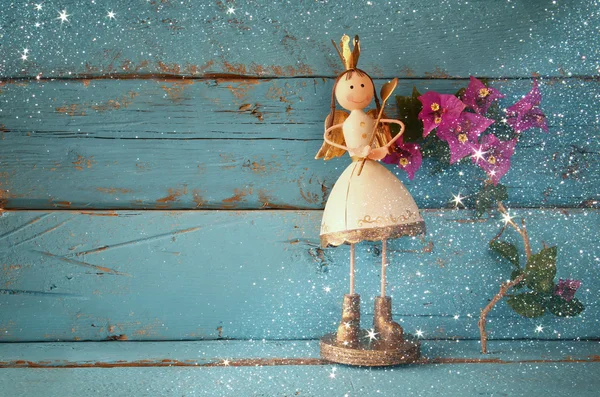 Image of cute fairy princess on wooden table. vintage filtered with glitter overlay — Stock Photo, Image