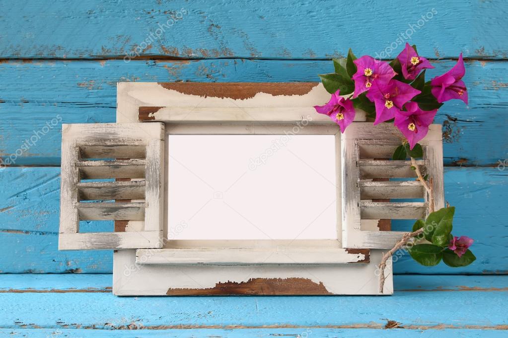 vintage blank frame next to beautiful purple mediterranean summer flowers. template, ready to put photography