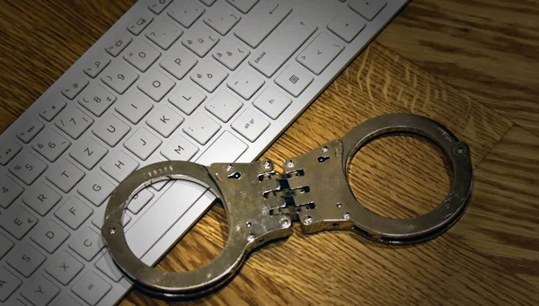 police handcuffs with pc keyboard