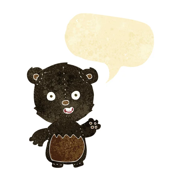 Cartoon waving black bear cub with speech bubble — Stock Vector