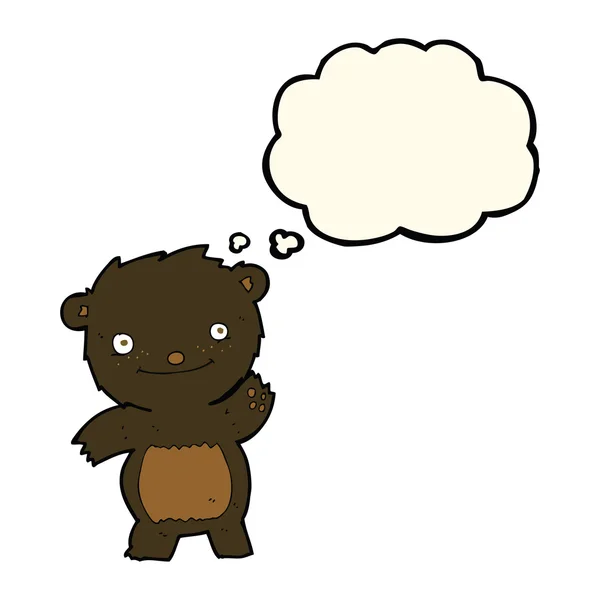 Cartone animato agitando cucciolo di orso nero con bolla di pensiero — Vettoriale Stock