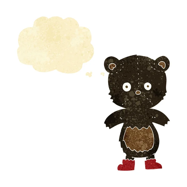Desenho animado filhote de urso preto com bolha de pensamento — Vetor de Stock