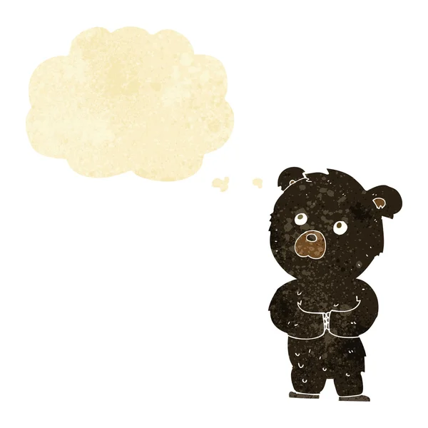 Cartoon black bear cub with thought bubble — Stock Vector