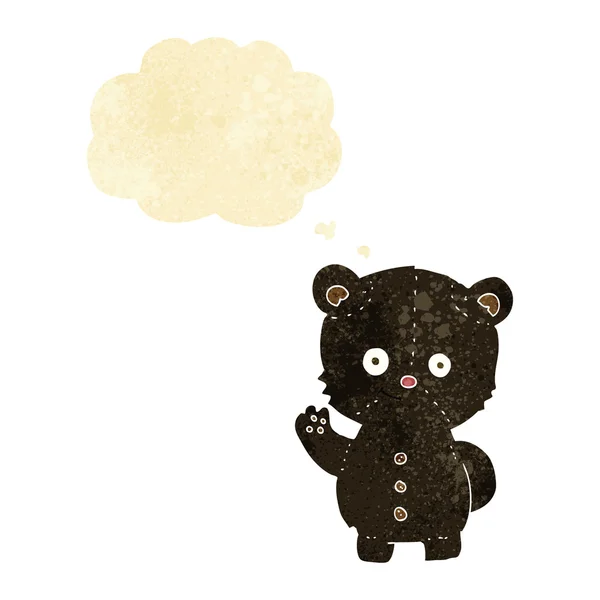 Cartone animato agitando cucciolo di orso nero con bolla di pensiero — Vettoriale Stock