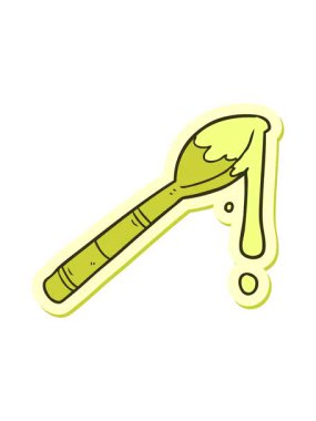 Bir kaşık dolusu balın renkli yapıştırmasını değiştiriyor.