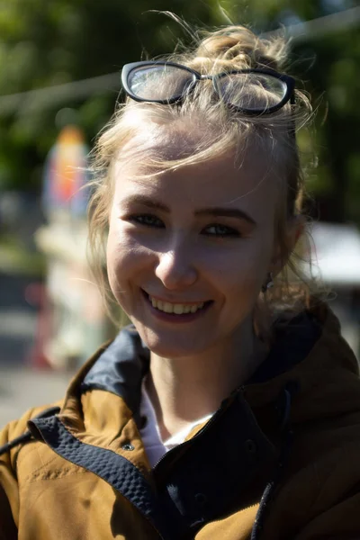 Stock image girl with glasses in the park in sunny weather