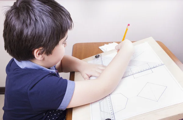 Boy draws on a T-square building on plotting — Stock Photo, Image