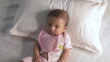 Babası mutlu bir ruh halinde yatakta uzanan şirin Hintli yeni doğmuş bebek. Babacık onu güldürdüğünde bebek gülümsüyor. Kapalı portre, tatlı küçük bebek. Çocukluk geçmişi. Stok görüntüleri