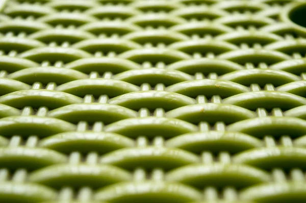 Chinese seamless pattern on green color plastic screen. Close up. Abstracts and backgrounds. Repeat vector knitted Design and pattern element Selective Focus.