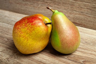 Armutlar. Ahşap bir zeminde iki taze organik armut. Vejetaryen, vejetaryen sağlıklı yiyecekler. Diyet organik ürün. Seçici yumuşak odaklanma. Sonbahar hasadı.