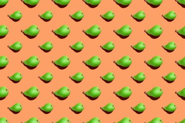 Sulu yeşil armut deseni. Turuncu arka planda taze armutların renksiz deseni. Turuncu yüzeyde taze olgun organik armutlar izole edilmiş. Vejetaryen, vejetaryen sağlıklı yiyecekler. Diyet organik ürün.