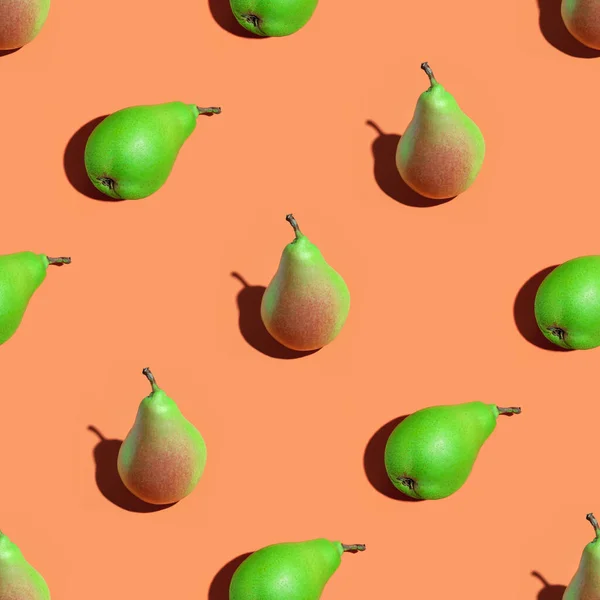 Juicy pears. Fruit seamless pattern of fresh juicy pears on an orange background. Ripe organic pears isolated on an orange surface. Vegan, vegetarian healthy food. Diet organic product.