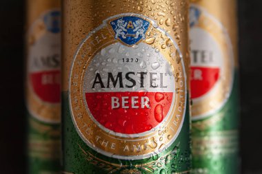 Su damlalı bira kutuları. Siyah arka planda ıslak kutuların içinde AMSTEL birası. Hollanda 'dan dünyaca ünlü bir marka. Seçici yumuşak odaklanma. Kiev. Ukrayna. Haziran-26.2021.