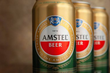 Bira kutuları. Soyut kahverengi arka planda yakın plan kutularda AMSTEL birası. Hollanda 'nın dünyaca ünlü markası. Seçici yumuşak odaklanma. Kiev. Ukrayna. Haziran-26.2021.