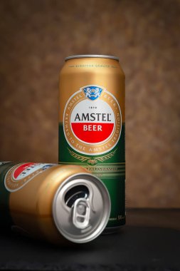 Bira kutuları. Arka planda dolu ve boş bira kutuları var. AMSTEL, Hollandalı dünyaca ünlü bir markadır. Seçici yumuşak odaklanma. Kiev. Ukrayna. Haziran-26.2021