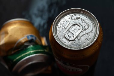 Bira kutusu. Islak buruşuk ve tam buruşuk bira kutuları yoğunlaştırılmış su damlaları koyu arka plan, üst manzara. AMSTEL, Hollandalı dünyaca ünlü bir markadır. Seçici odaklanma. Kiev. Ukrayna. Haziran-26.2021