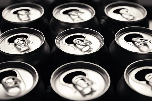 Beer cans. Close-up of multicolored aluminum cans. Many open empty cans. Recycling and reuse. Black and white image. Selective soft focus.