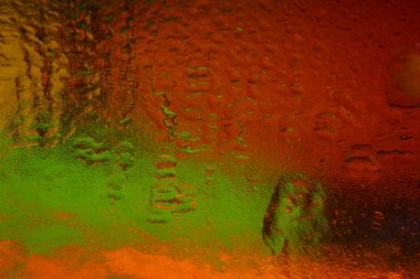 Colorful wet texture. Abstract macro texture with gradient. Dark background. Selective soft focus