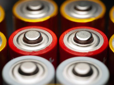Alkaline batteries. Close-up of a stack of AA batteries. Soft focus
