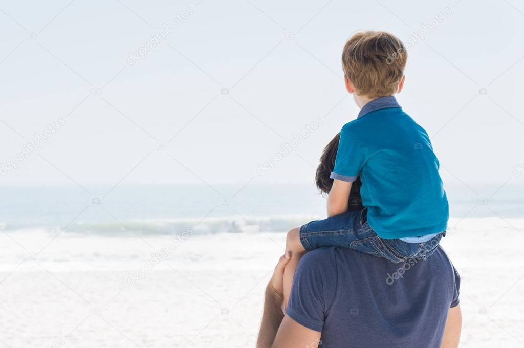 Father and son on sea beach